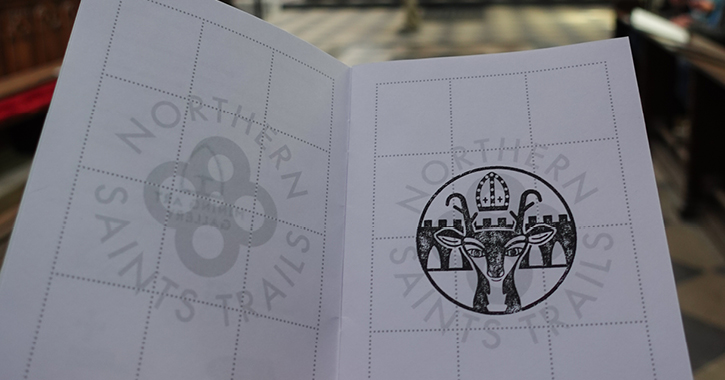 Inside pages of the Northern Saints Passport with a stamp on the page. Image by Intrepid Escape